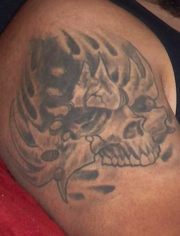 Skull tattoo on his arm half the picture