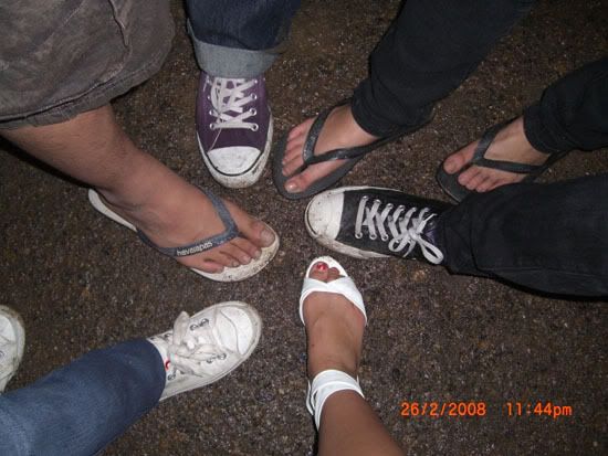 our shoes covered in mud from the puddles