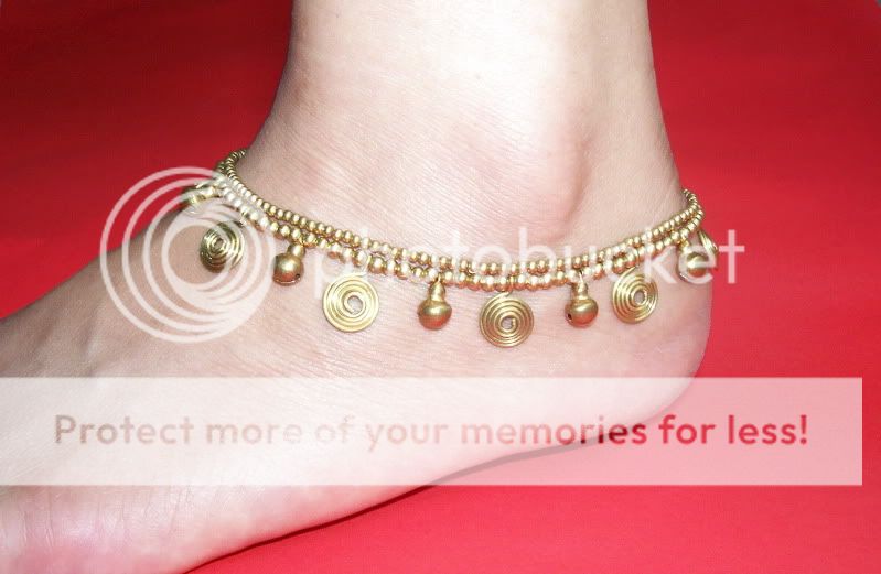 Superbly handcrafted using brass beads , spirals and bells .